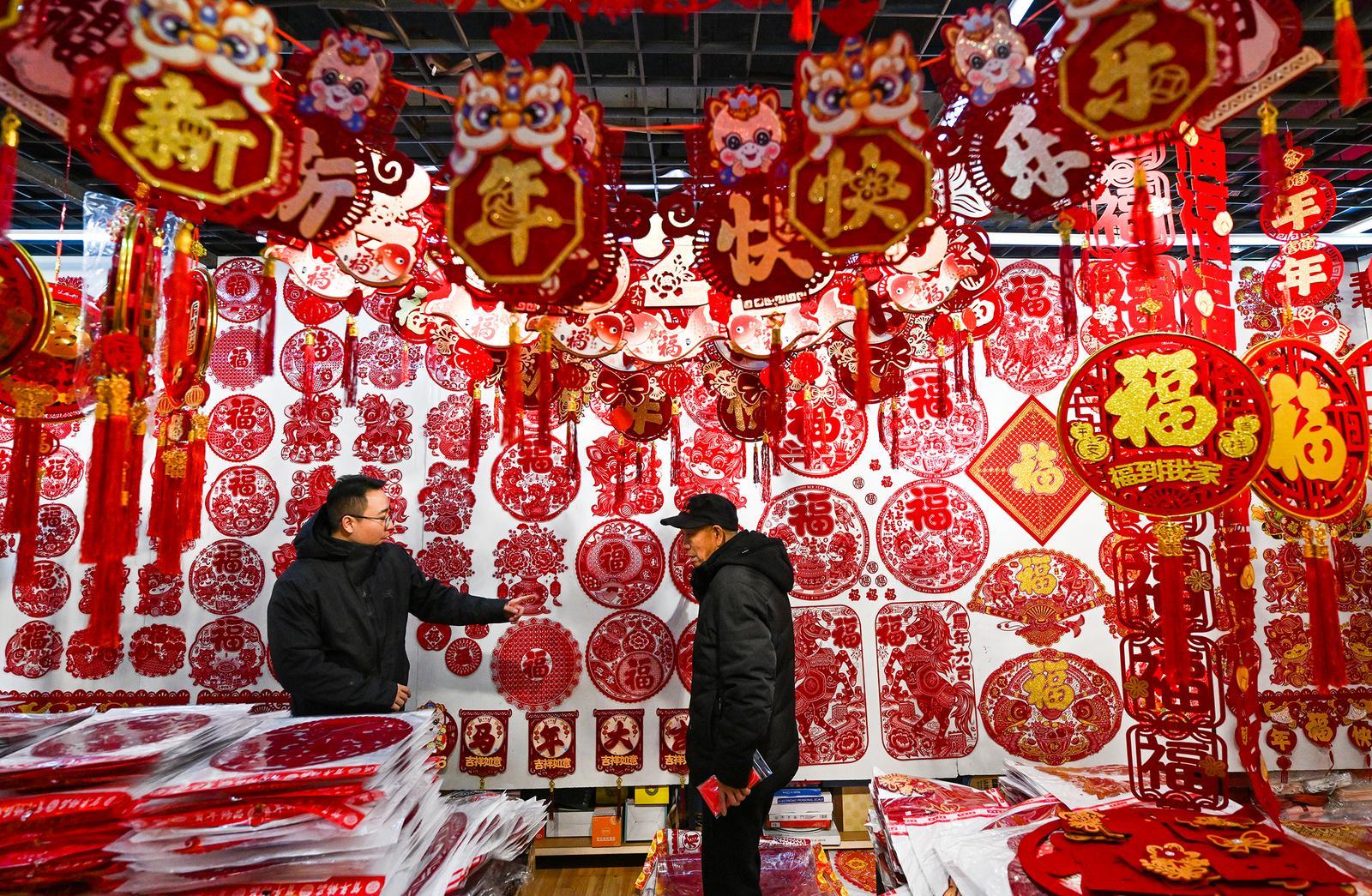 临近春节,太原市尖草坪商品批发市场,市民在选购节庆用品。 李兆民 摄